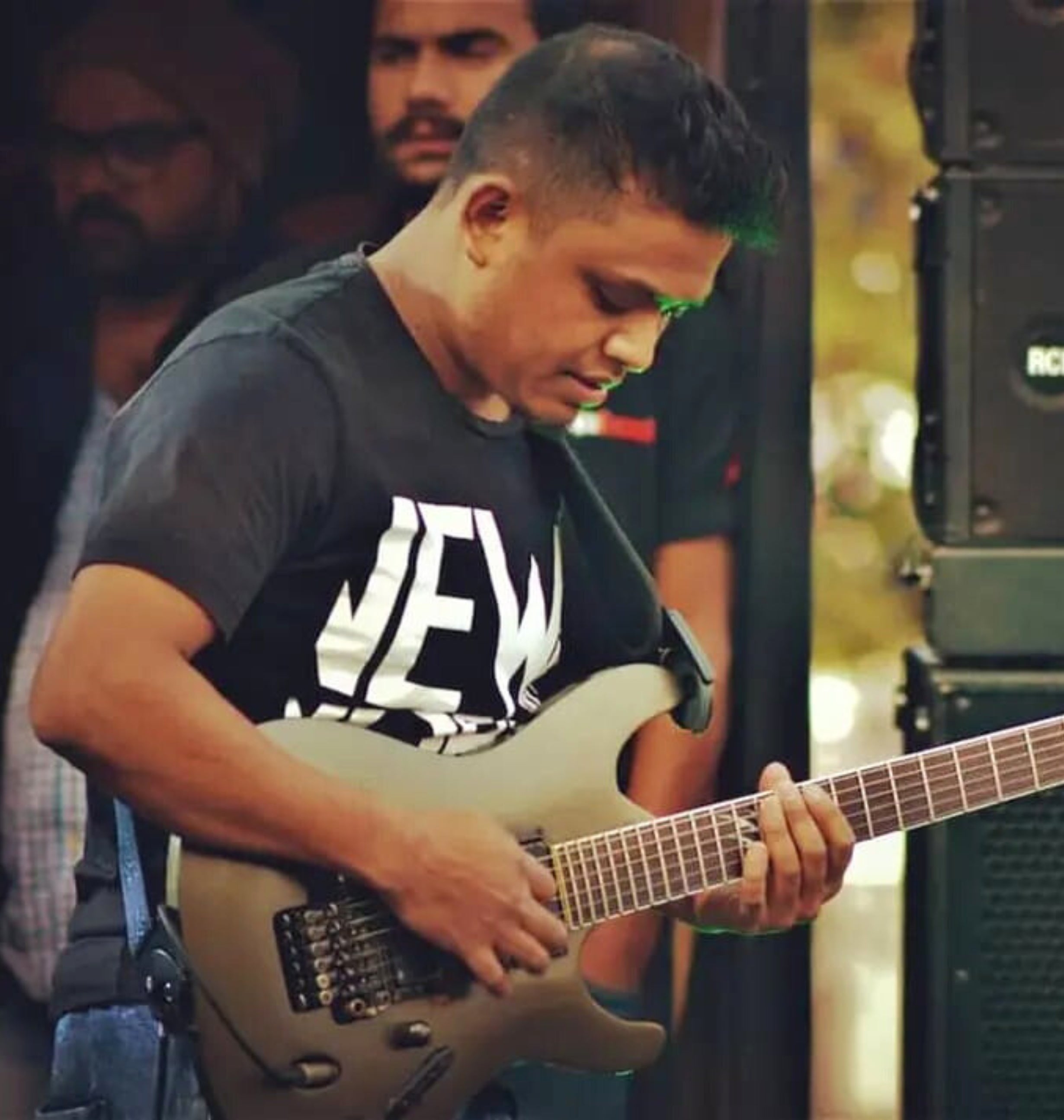 A musician named 'Kunal Singh' playing a Guitar