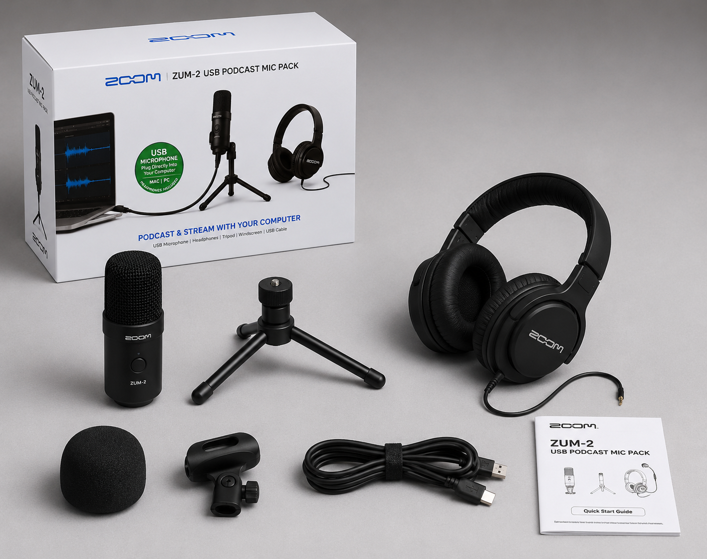 Unboxed Zoom ZUM-2 podcast kit showing the microphone, headphones, and accessories next to its product packaging.